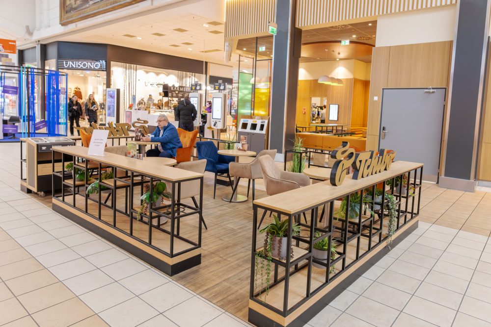 Stoliki przed sklepem Tchibo w M1 Kraków